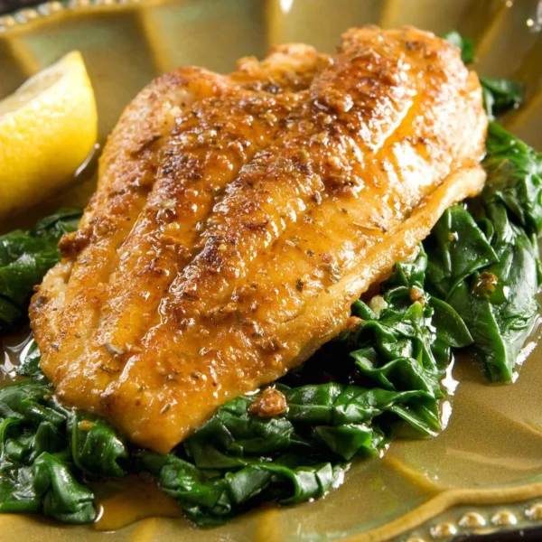 Spiced catfish fillet with spinach and gravy
