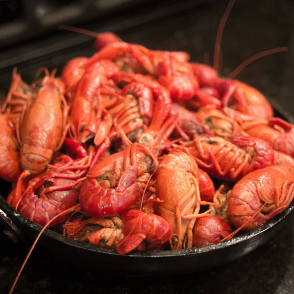 A beautiful red skillet full of crawfish, freshly steamed