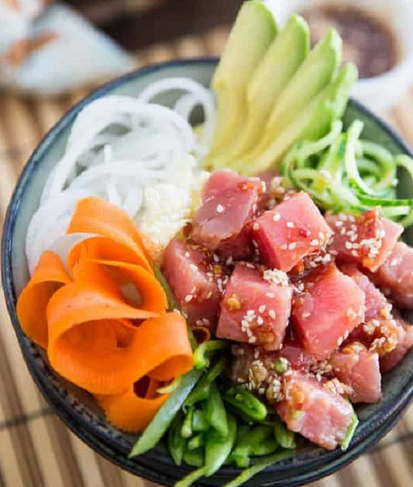 Vietnamese Tuna Poke Served in a Bowl with carrot slices, cucumber and avocado
