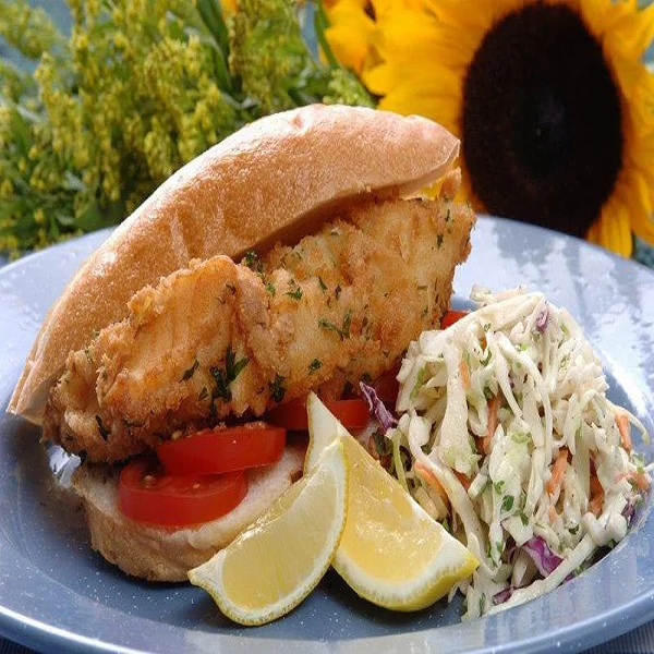 Chemical free grouper sandwich with coleslaw and lemon slices.