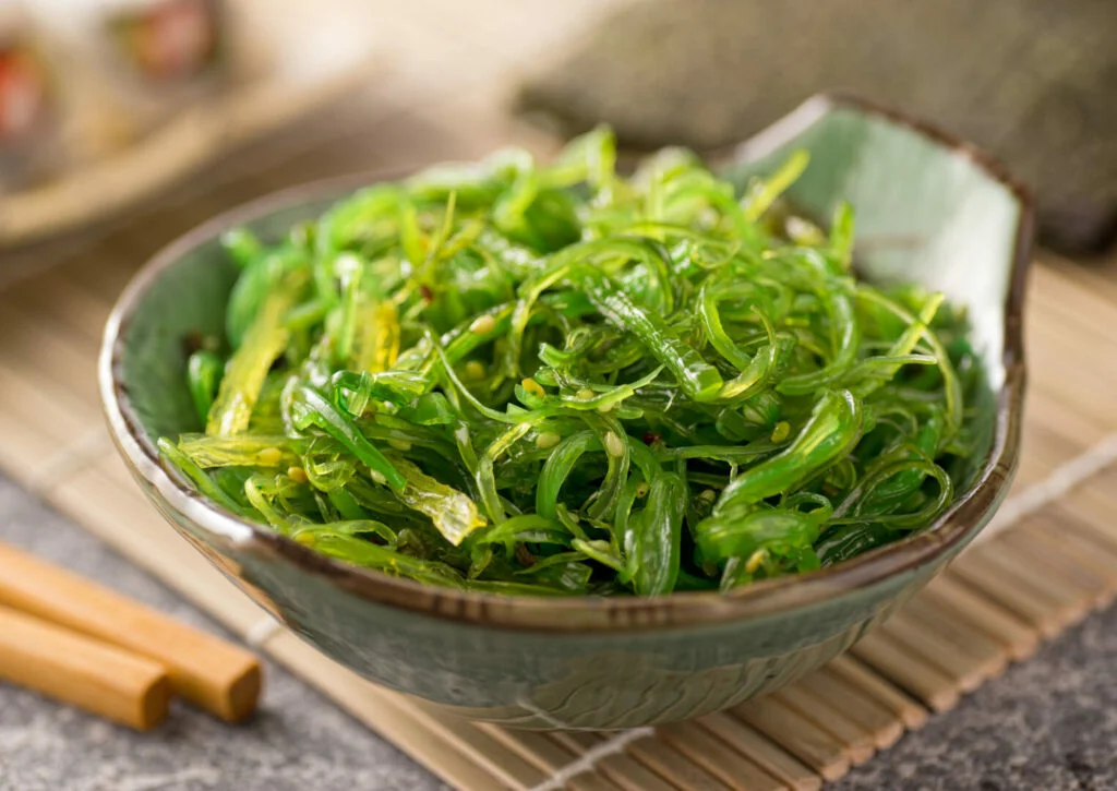 A delicious fresh seaweed salad in a bowl with chopsticks