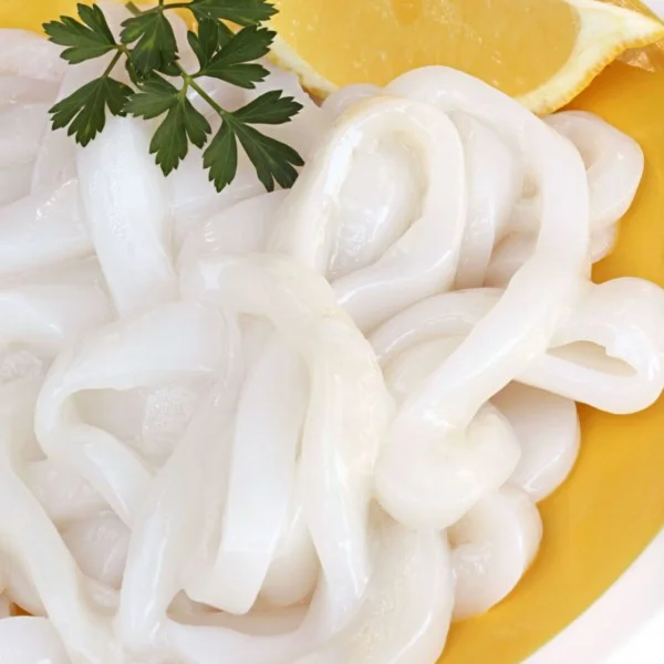 raw calamari rings on a bright yellow plate